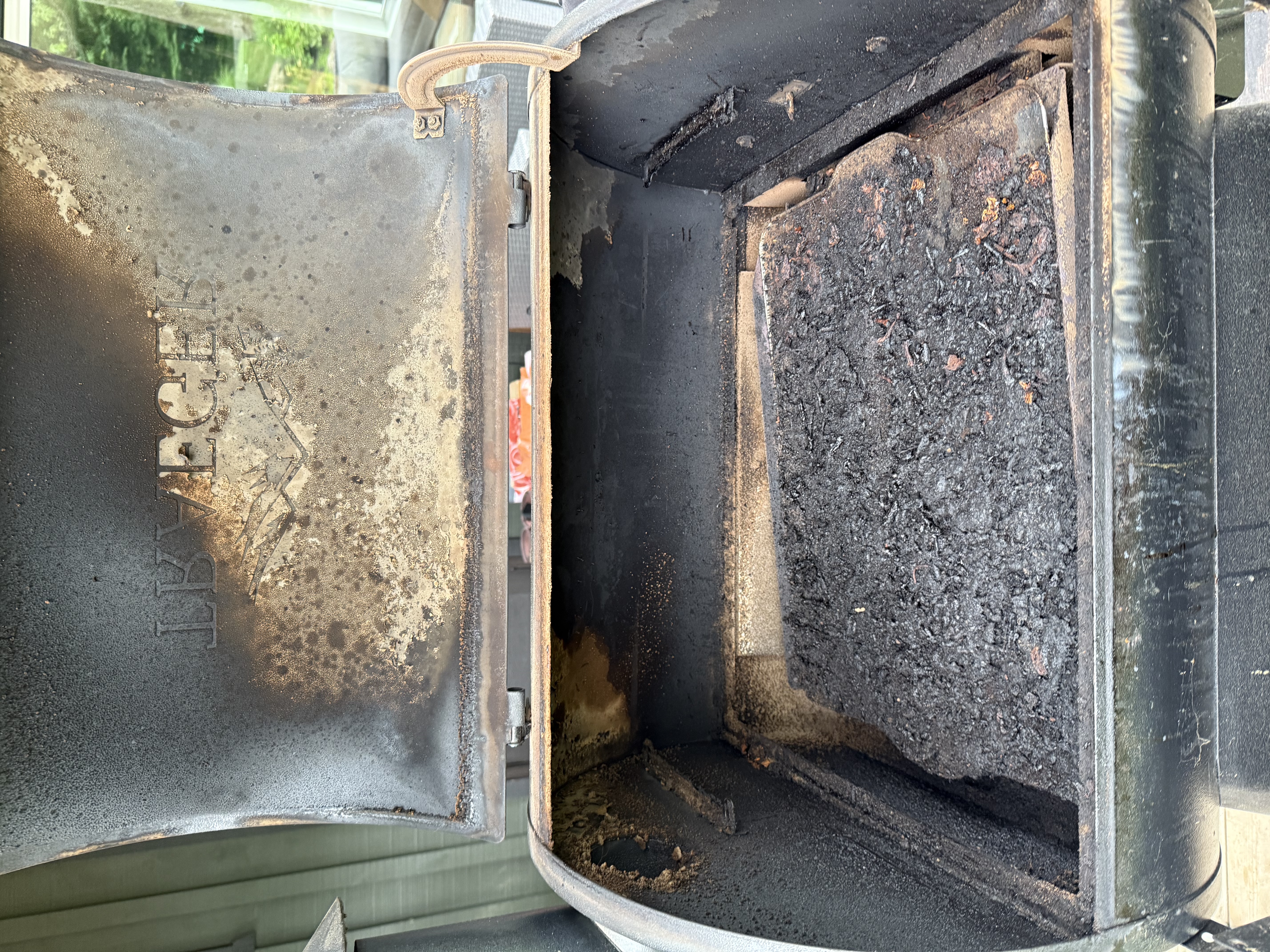 BBQ interior before cleaning — heavy grease buildup