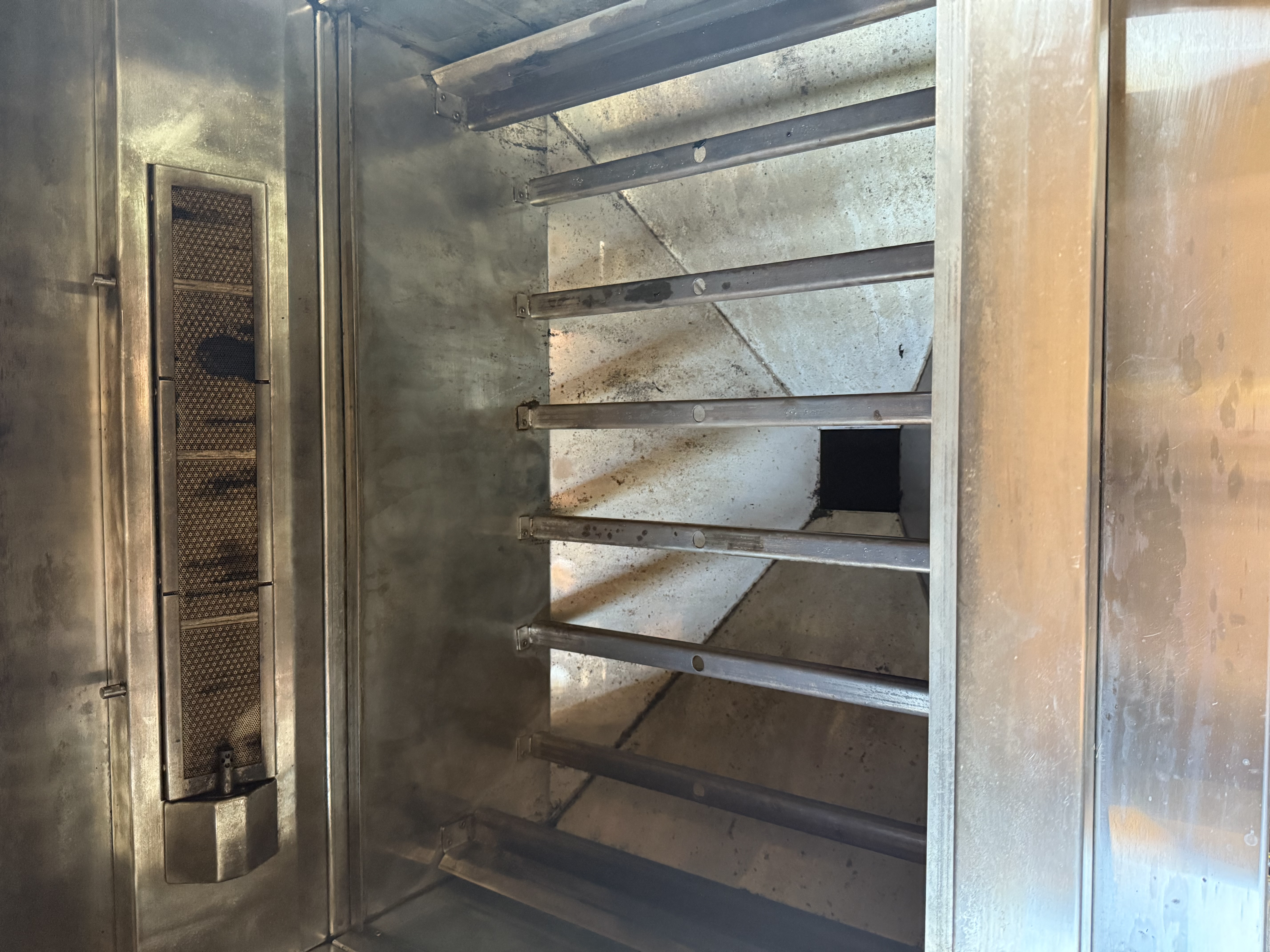 Inside of a heavily soiled grill before cleaning